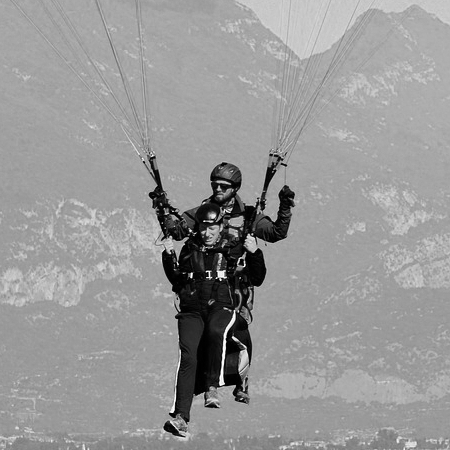 Man and woman flying with a parachute